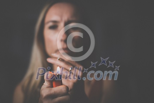 Mid-aged woman lighting a cigarette at home, getting her nicotine daily dose, unable to resist to her unhealthy habit Mid-aged woman lighting a cigarette at home, getting her nicotine daily dose, unable to resist to her unhealthy habit