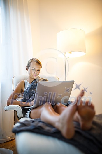 Pretty, young woman working from home during a pandemic coronavirus crisis