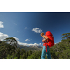 Pretty, female hiker in high mountains packing her backpack