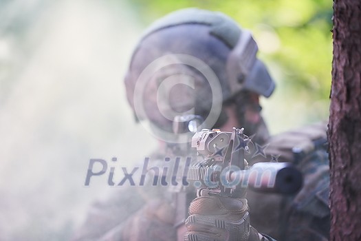 modern warfare soldier in action aiming at weapon laser sight optics in combat position while searching for a target in battle modern warfare soldier in action aiming at weapon laser sight optics in combat position while searching for a target in battle