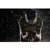 triathlon athlete riding professional racing bike fast  at night with bad weather and falling rain