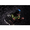 triathlon athlete riding professional racing bike fast  at night with bad weather and falling rain