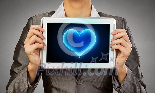 Beautiful young woman holding tablet pc with love heart Beautiful young woman holding tablet pc with love heart