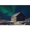 Traditional Norwegian fisherman's cabins  northern Norway. Winter season bad weather at night with northern lights aurora borealis