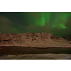 Aurora borealis Green northern lights above mountains on the Lofoten islands, Norway. Night sky with polar lights. Night winter landscape with aurora.