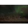 Aurora borealis Green northern lights above mountains on the Lofoten islands, Norway. Night sky with polar lights. Night winter landscape with aurora.