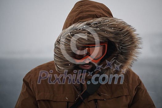 portrait local authentic eskimo man at winter in stormy weather wearing warm fur jacket portrait local authentic eskimo man at winter in stormy weather wearing warm fur jacket