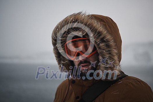 portrait local authentic eskimo man at winter in stormy weather wearing warm fur jacket portrait local authentic eskimo man at winter in stormy weather wearing warm fur jacket