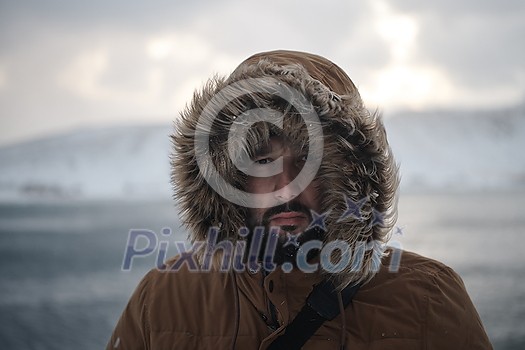 portrait local authentic eskimo man at winter in stormy weather wearing warm fur jacket portrait local authentic eskimo man at winter in stormy weather wearing warm fur jacket