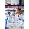 Female researcher carrying out scientific research in a lab (shallow DOF; color toned image)