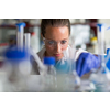 Female researcher carrying out scientific research in a lab (shallow DOF; color toned image)