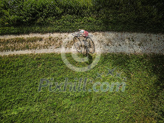 Pretty, young woman riding her mountain bike on a forest path. Enjoying active leisure time outdoors. Pretty, young woman riding her mountain bike on a forest path. Enjoying active leisure time outdoors.