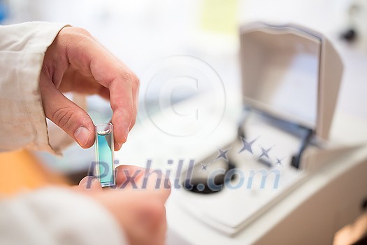 Researcher carrying out scientific research in a lab (shallow DOF; color toned image) Researcher carrying out scientific research in a lab (shallow DOF; color toned image)