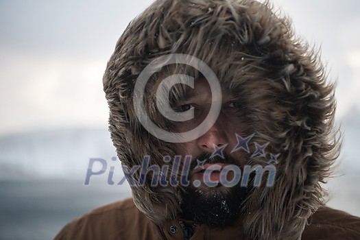 portrait local authentic eskimo man at winter in stormy weather wearing warm fur jacket portrait local authentic eskimo man at winter in stormy weather wearing warm fur jacket