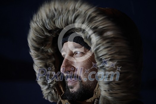 portrait local authentic eskimo man at winter in stormy weather wearing warm fur jacket in northern cold night portrait local authentic eskimo man at winter in stormy weather wearing warm fur jacket in northern cold night