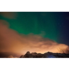Aurora borealis Green northern lights above mountains on the Lofoten islands, Norway. Night sky with polar lights. Night winter landscape with aurora.