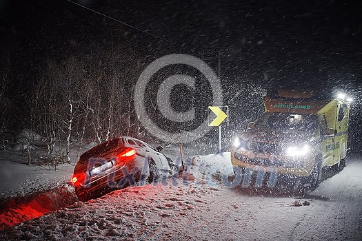 car accident on slippery winter road at night with heavy snow fall and paramedic ambulance first aid car car accident on slippery winter road at night with heavy snow fall and paramedic ambulance first aid car