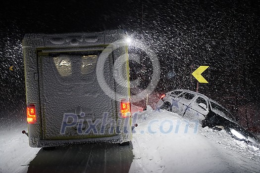 car accident on slippery winter road at night with heavy snow fall and paramedic ambulance first aid car car accident on slippery winter road at night with heavy snow fall and paramedic ambulance first aid car