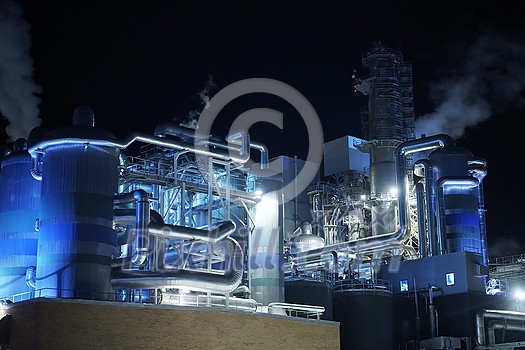 Factory at Night Atmospheric Environmental Air Pollution From Industrial Smoke. Pipes Steel Tank Plant Wood and Paper  Production. Thick Smoke and Steam.