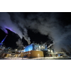 Factory at Night Atmospheric Environmental Air Pollution From Industrial Smoke. Pipes Steel Tank Plant Wood and Paper  Production. Thick Smoke and Steam.