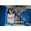 Young woman sitting in the train after a day of work . Train passenger traveling sitting relaxed and enjoying the ride