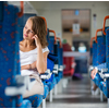 Young woman sitting in the train after a day of work . Train passenger traveling sitting relaxed and enjoying the ride