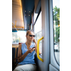 Young woman on a city tram, heading for the office early, before the rush hour begins