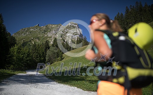 Pretty, female climber on a via ferrata -  climbing on a rock in Swiss Alps - Approach phase