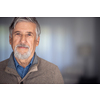 Portrait of happy senior man smiling at home. Close up face of elderly guy enjoying retirement.