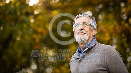 Portrait of a senior man outdoors, optimism, good health, happyness radiates of the man's face, expression Portrait of a senior man outdoors, optimism, good health, happyness radiates of the man's face, expression