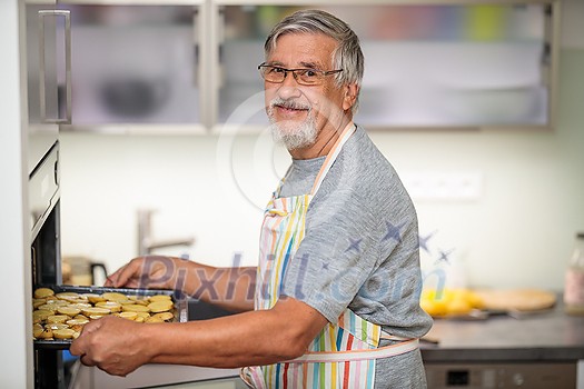 Senior man prepares healthy version of potatoes in the oven
