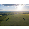Panoramic bird's eye view from drone of outdoors landscape above farmlands, agricultural fields, and forests on bright sky background on a summer sunny day. Ukraine, Uman city.