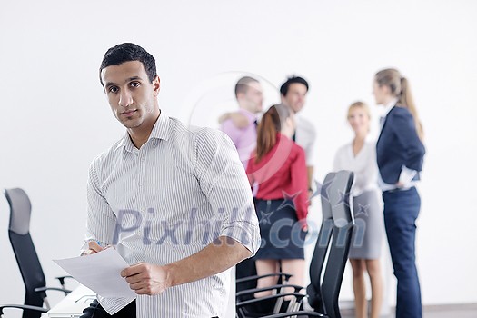 Confident young business man attending a meeting with his colleagues