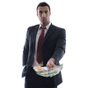 Portrait of a business man holding and catch falling money bills, isolated on white background in studio