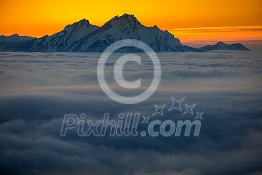 Splendid apline scenery. High mountains with fog and lovely evening light.