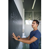 Students in a classroom - handsome student solving a math problem on a blackboard during math class