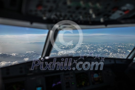 Commercial airliner airplane cockpit during flight with great weather below