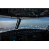 Commercial airliner airplane cockpit during flight with great weather below