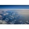 View from a cockpit of a commercial airliner airplane over a beautiful mountain range