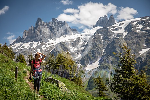 Pretty, female hiker/climber in a lovely alpine setting of Swiss Alps