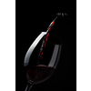Red wine pouring into wine glass on dark background - lovely, rich, full bodied, ruby coloured, Shiraz