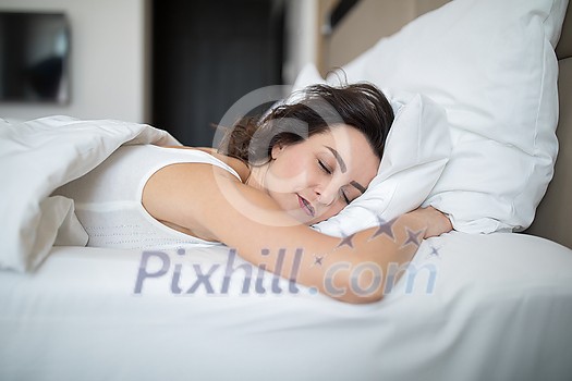 Beautiful young woman sleeping in bed in the morning Beautiful young woman sleeping in bed in the morning