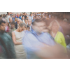 Crowd of people walking on city street - motion blurred image with unrecognizable faces - Young woman standing still, feeling down, depressed