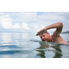 Senior man swimming in the Sea/Ocean - enjoying active retirement, having fun, taking care of himself, staying fit