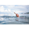 Senior man swimming in the Sea/Ocean - enjoying active retirement, having fun, taking care of himself, staying fit (shallow DOF)