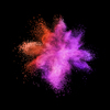 Creative chaotic powder explosion or burst in red and purple colors on a black background with copy space.