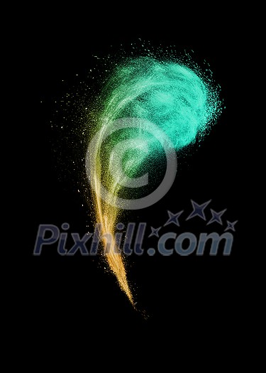 Decorative powder burst or explosion in yellow and green colors in the shape of curved cloud on a black background with copy space.