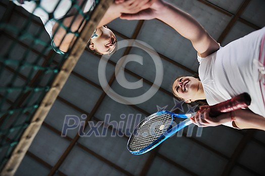 young girls playing tennis game indoori in tennis court young girls playing tennis game indoori in tennis court