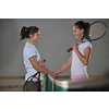 young girls playing tennis game indoori in tennis court