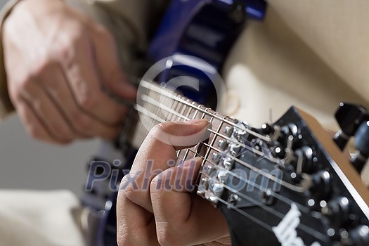 Close up of male hands playing electric guitar Close up of male hands playing electric guitar